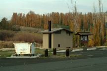 Vaulted Toilet and Garbage Dumpster